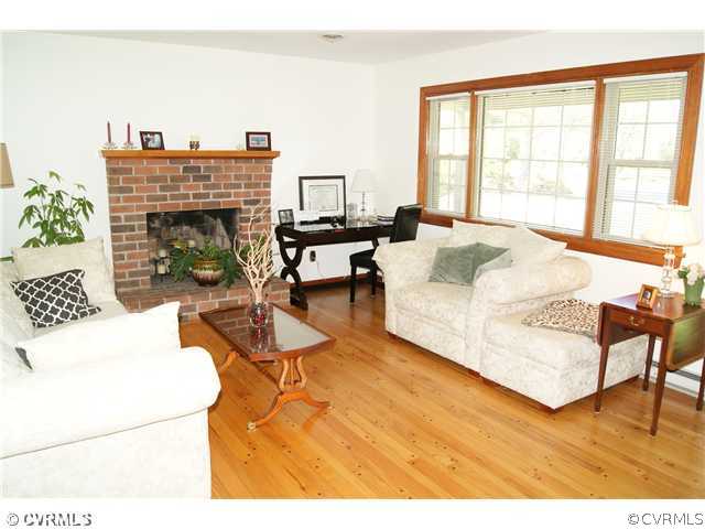 7941 Gregg Road Henrico, VA 23231 - Photo 3 of 12 a living room with furniture a fireplace and a large window