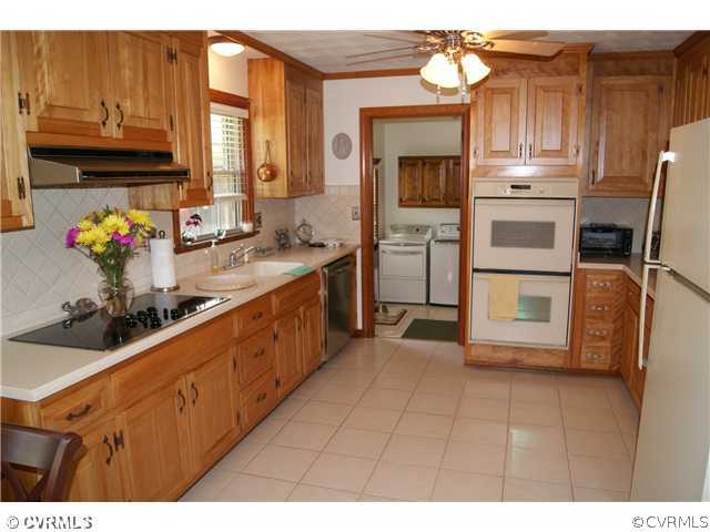 7941 Gregg Road Henrico, VA 23231 - Photo 5 of 12 a kitchen with a sink cabinets and appliances