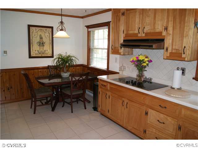 7941 Gregg Road Henrico, VA 23231 - Photo 6 of 12 a kitchen with granite countertop a sink cabinets and dining table