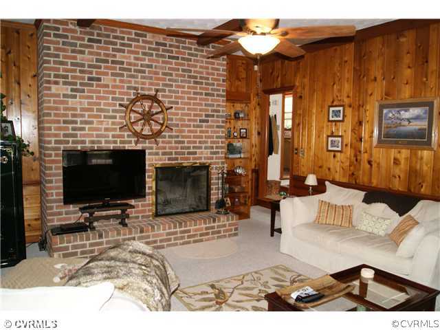 7941 Gregg Road Henrico, VA 23231 - Photo 8 of 12 a living room with furniture a flat screen tv and a fireplace