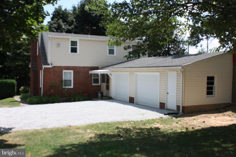 8404 Rocky Springs Road Frederick, MD 21702 - Photo 2 of 26 a front view of a house with a yard