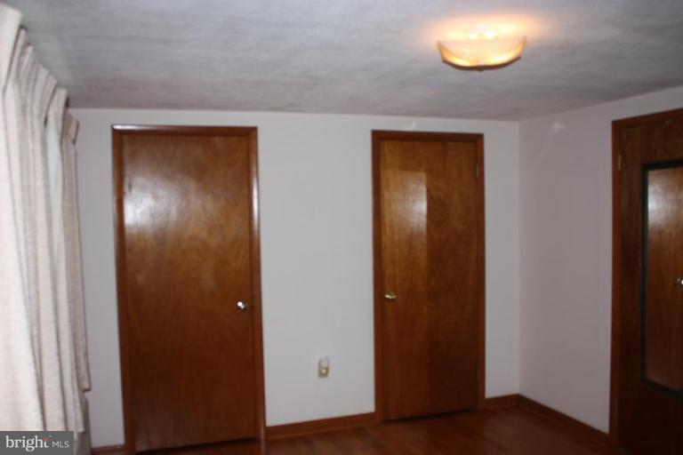 8404 Rocky Springs Road Frederick, MD 21702 - Photo 5 of 26 an empty room with wooden floor and closet