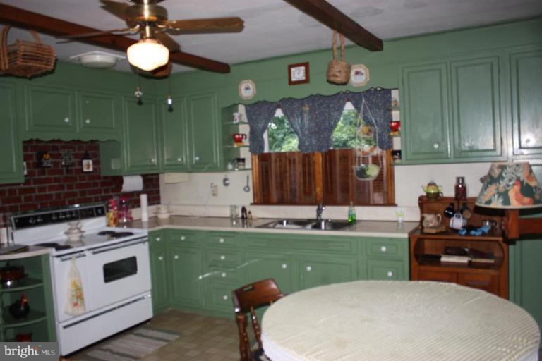 8404 Rocky Springs Road Frederick, MD 21702 - Photo 8 of 26 a kitchen that has a sink and a stove in it