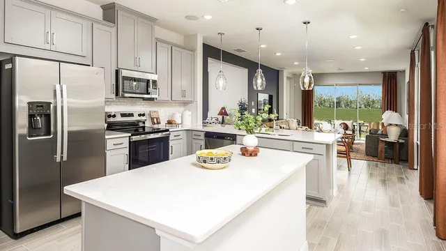 a kitchen with stainless steel appliances a sink and a refrigerator