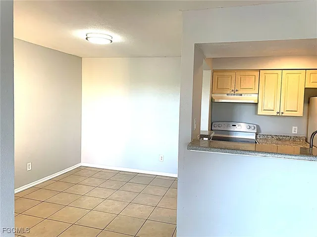 a kitchen with a stove and a refrigerator