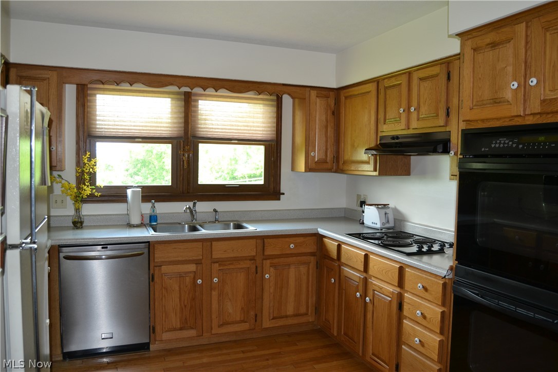 742 Highland Ridge Road Lowell, OH 45744 - Photo 18 of 31 U[shaped kitchen with ample storage in cabinets and a large pantry.