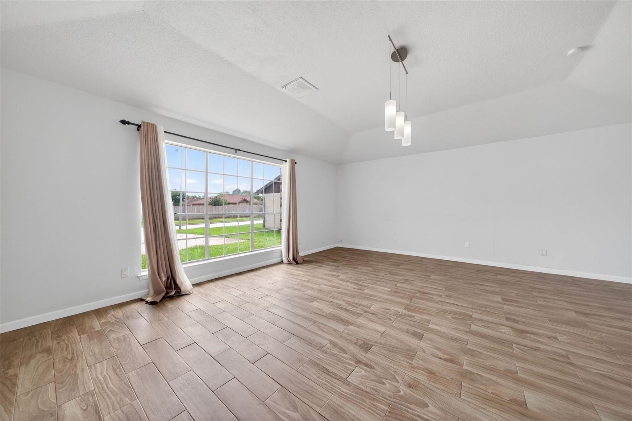 17002 Dew Drop Lane Houston, TX 77095 - Photo 3 of 24 wooden floor in an empty room with a window
