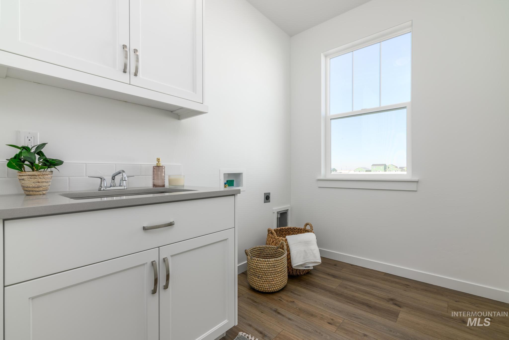855 West Bay Street Middleton, ID 83644 - Photo 13 of 13 Laundry room featuring hookup for a washing machine, dark wood-type flooring, cabinet space, and hookup for an electric dryer