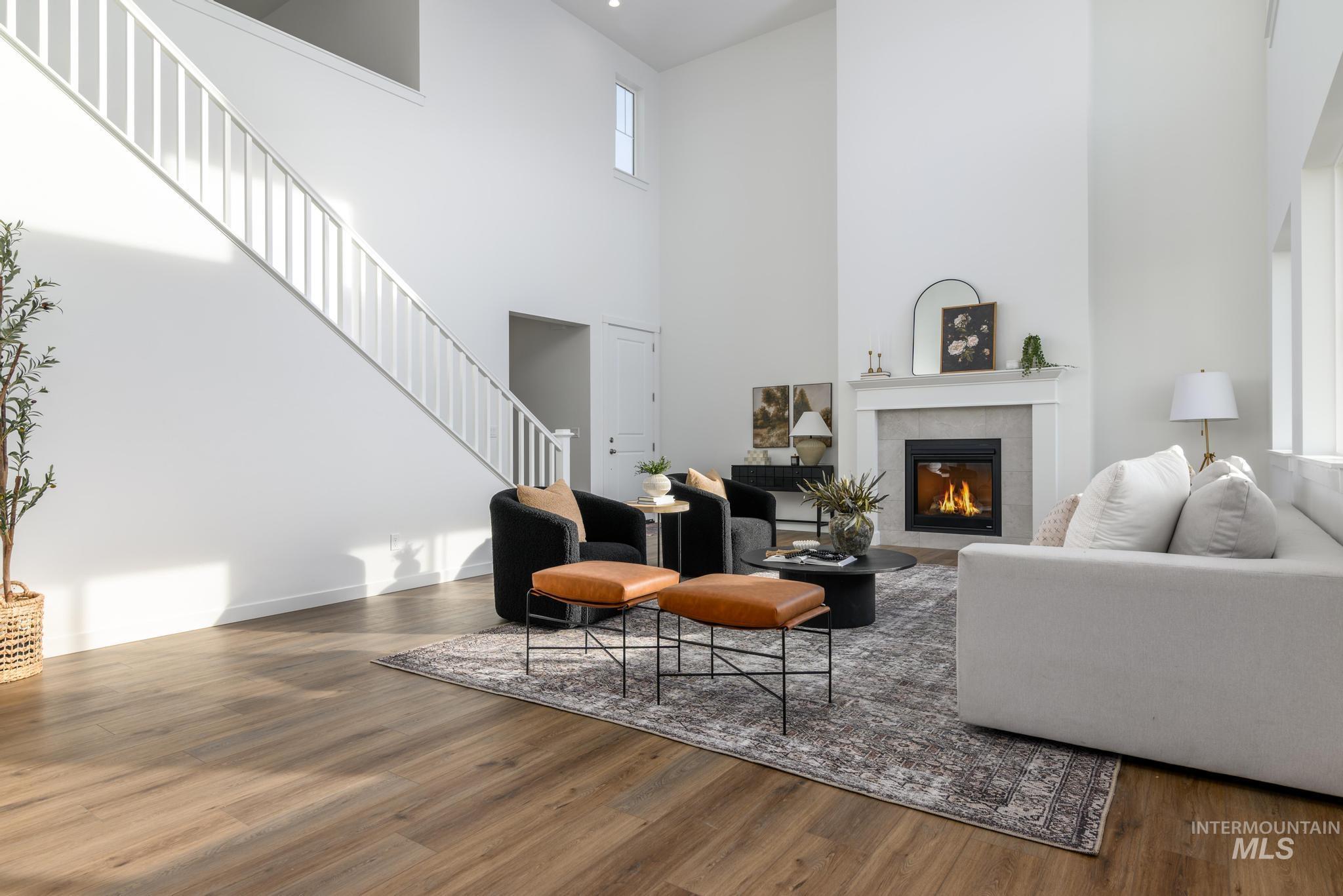 855 West Bay Street Middleton, ID 83644 - Photo 2 of 13 Living area with wood finished floors, a fireplace, and a high ceiling