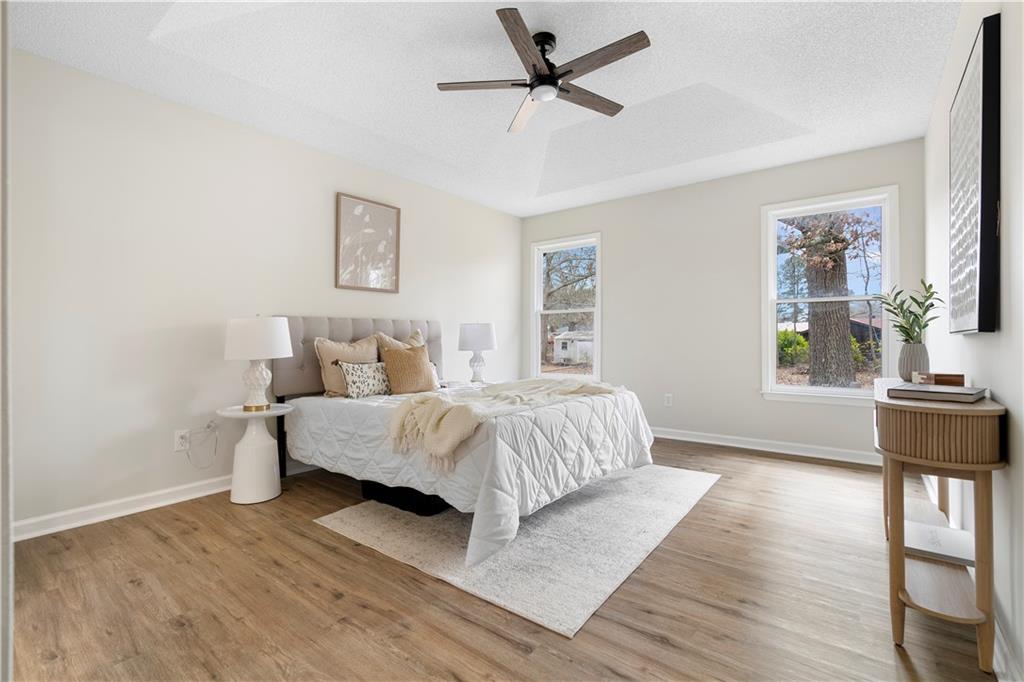 323 Lumpkin Street Winder, GA 30680 - Photo 16 of 30 a spacious bedroom with a bed a table and chair