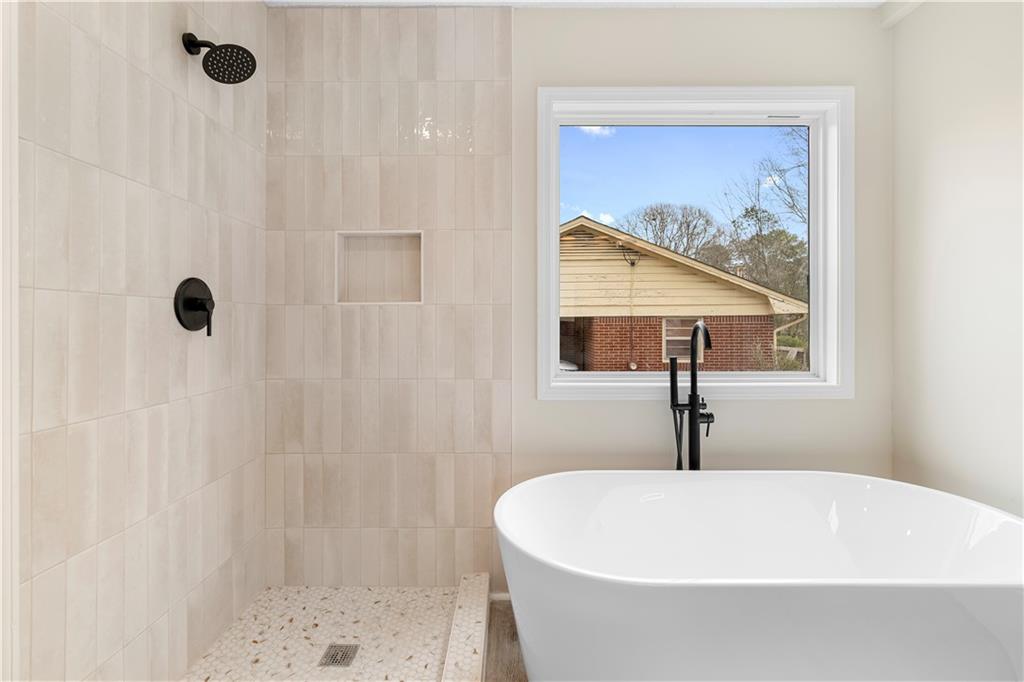 323 Lumpkin Street Winder, GA 30680 - Photo 19 of 30 a white bath tub sitting in a bathroom