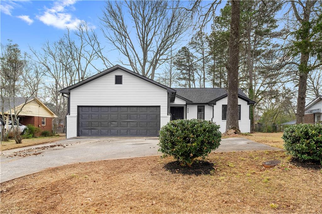 323 Lumpkin Street Winder, GA 30680 - Photo 2 of 30 a front view of a house with a yard and garage