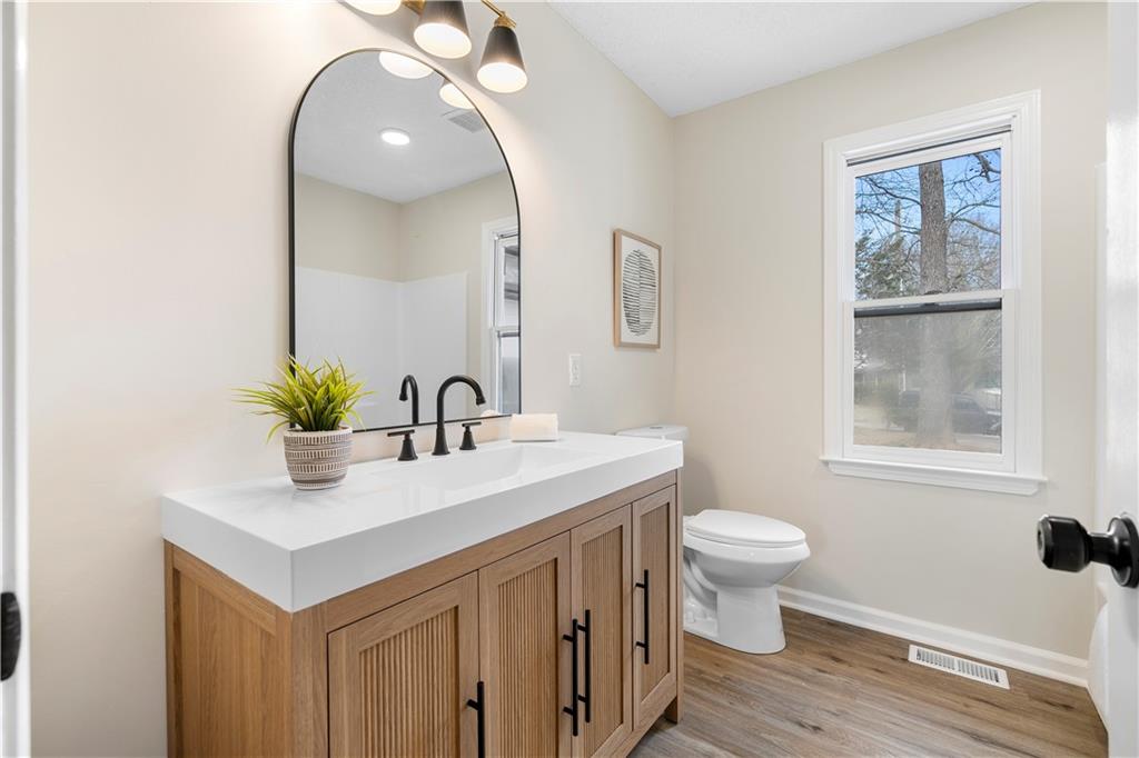 323 Lumpkin Street Winder, GA 30680 - Photo 23 of 30 a bathroom with a sink toilet and a mirror