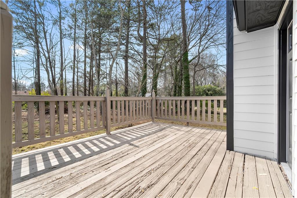 323 Lumpkin Street Winder, GA 30680 - Photo 26 of 30 a balcony with wooden floor and fence