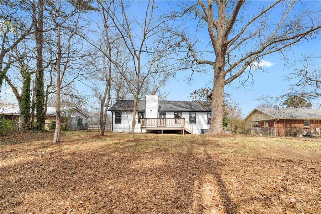 323 Lumpkin Street Winder, GA 30680 - Photo 27 of 30 a white house that has a tree in front of it