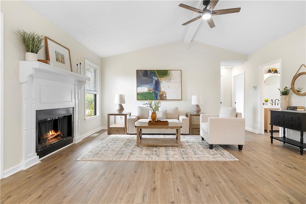 323 Lumpkin Street Winder, GA 30680 - Photo 5 of 30 a living room with furniture and a fireplace