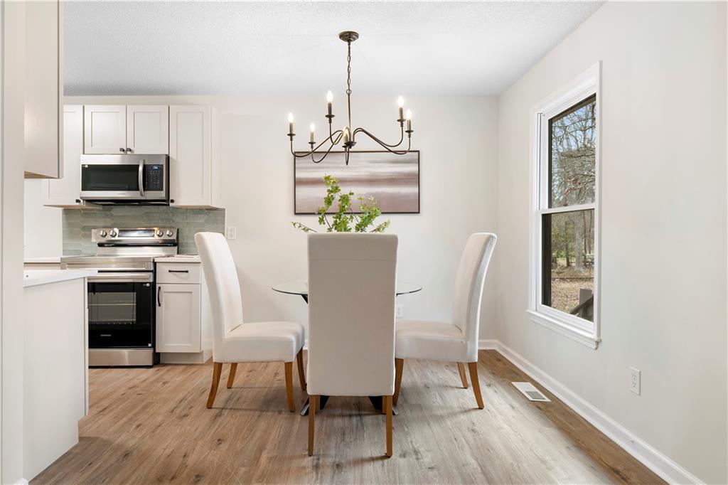 323 Lumpkin Street Winder, GA 30680 - Photo 9 of 30 a view of a dining room with furniture window and wooden floor