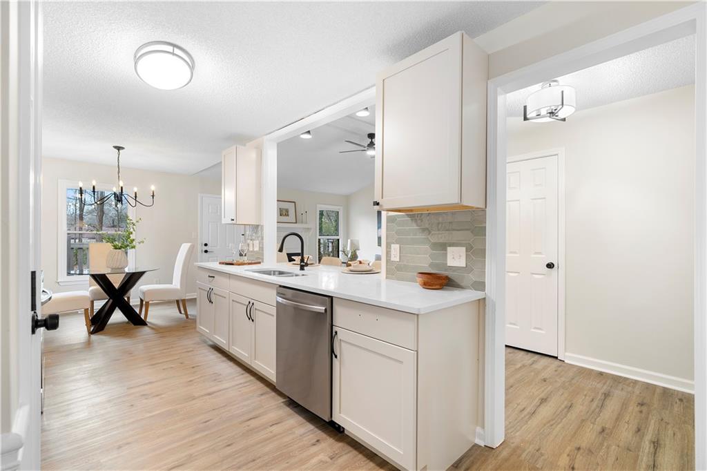 323 Lumpkin Street Winder, GA 30680 - Photo 10 of 30 a large white kitchen with a sink and wooden floor