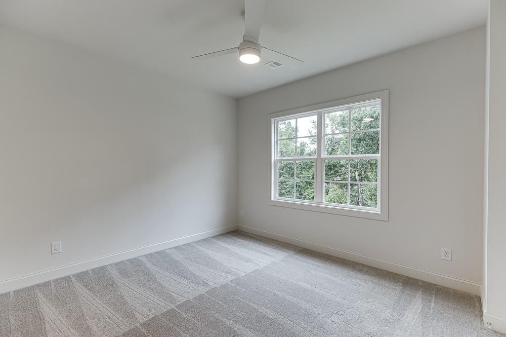 314 Level Creek Road Sugar Hill, GA 30518 - Photo 28 of 62 an empty room with windows and closet