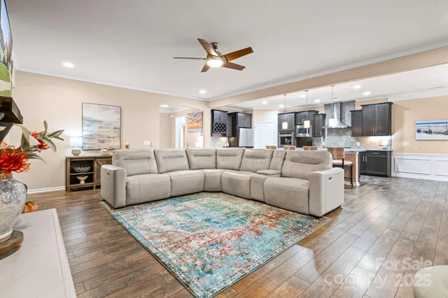a living room with furniture kitchen view and a table