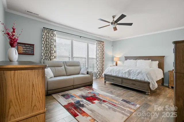 a bedroom with a bed couch and window