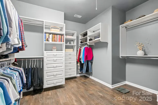 a view of walk in closet with clothes and shoes