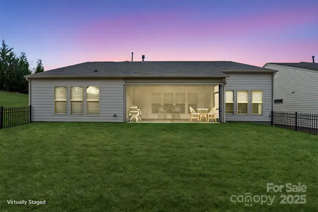 a front view of a house with a garden and yard
