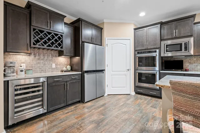 a kitchen with stainless steel appliances and refrigerator