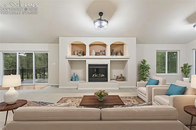 a large kitchen with stainless steel appliances kitchen island granite countertop a table chairs and a wooden floor