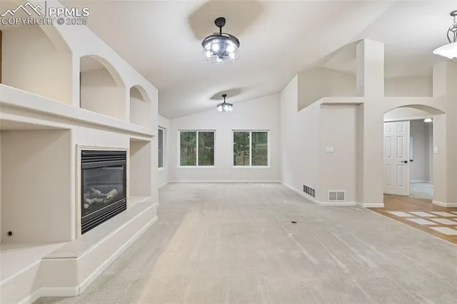 a kitchen with stainless steel appliances granite countertop a sink and a refrigerator