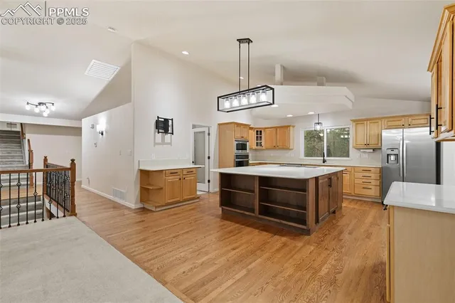 a bathroom with a granite countertop double vanity and a mirror