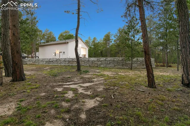a backyard of a house with barbeque oven fire pit table and chairs