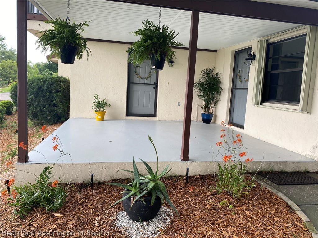 15 Victory Way Lake Placid, FL 33852 - Photo 2 of 36 a potted plant sitting in front of a house