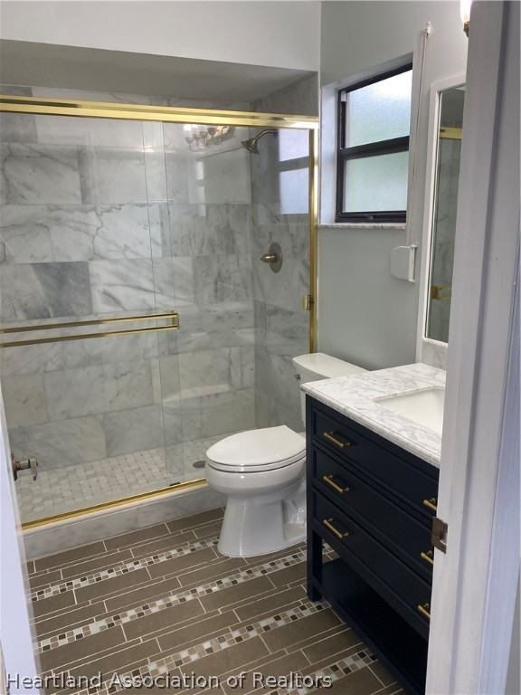 15 Victory Way Lake Placid, FL 33852 - Photo 25 of 36 a bathroom with a toilet a sink and shower