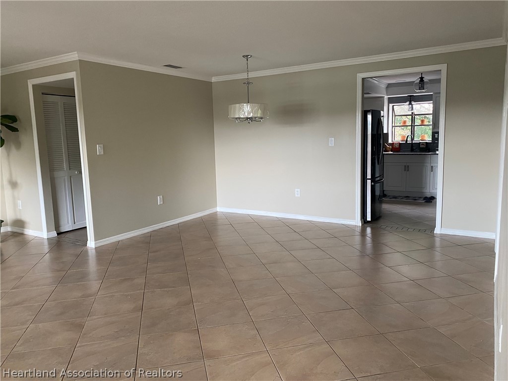 15 Victory Way Lake Placid, FL 33852 - Photo 5 of 36 wooden floor in an empty room and a bathroom