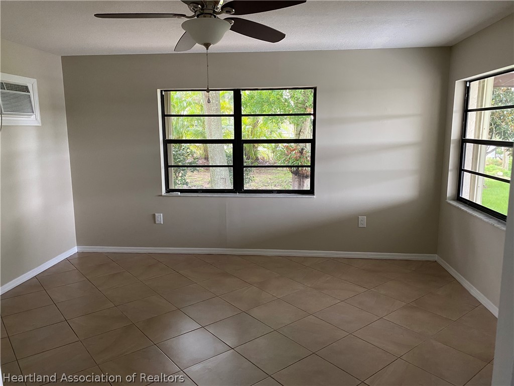 15 Victory Way Lake Placid, FL 33852 - Photo 8 of 36 an empty room with windows and fan