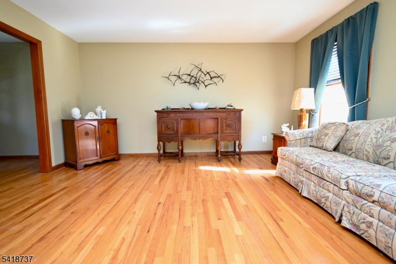 189 School House Road Oak Ridge, NJ 07438 - Photo 15 of 29 a living room with a bed and a dresser next to a window