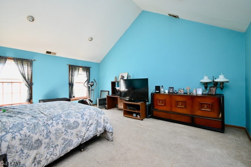 189 School House Road Oak Ridge, NJ 07438 - Photo 16 of 29 a bedroom with a bed and a television