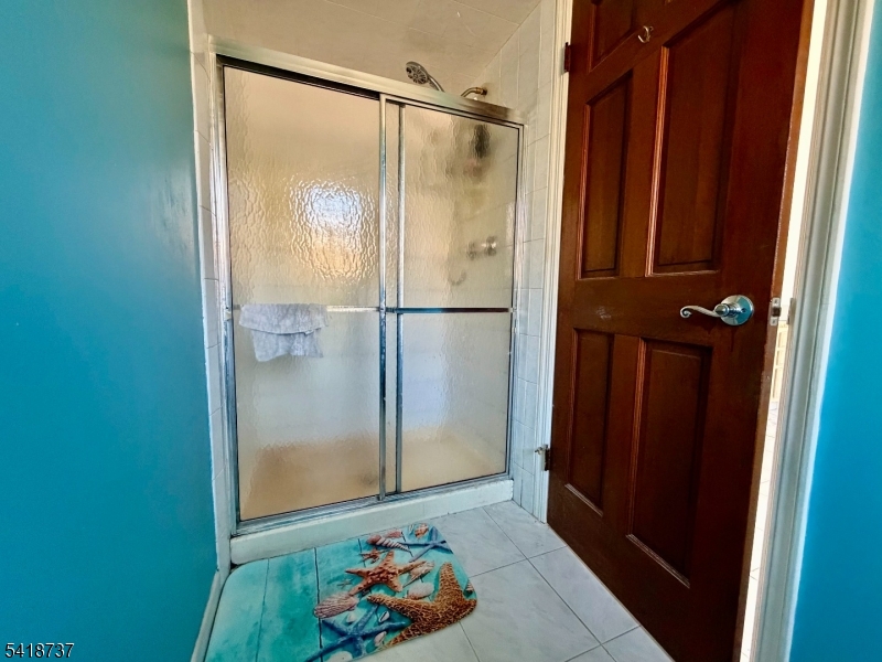 189 School House Road Oak Ridge, NJ 07438 - Photo 20 of 29 a bathroom with a glass shower door