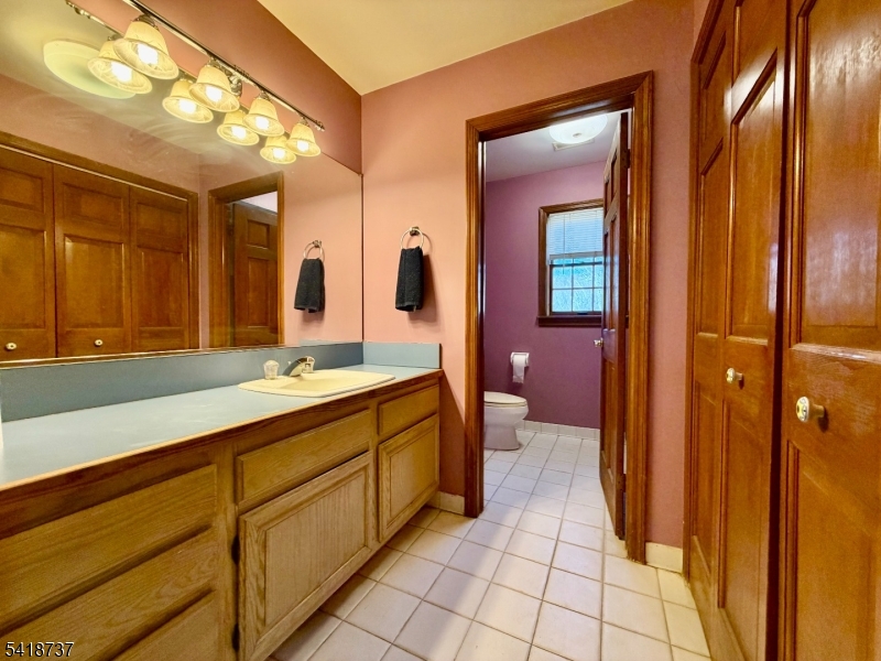 189 School House Road Oak Ridge, NJ 07438 - Photo 23 of 29 a bathroom with a sink a mirror and a bathtub