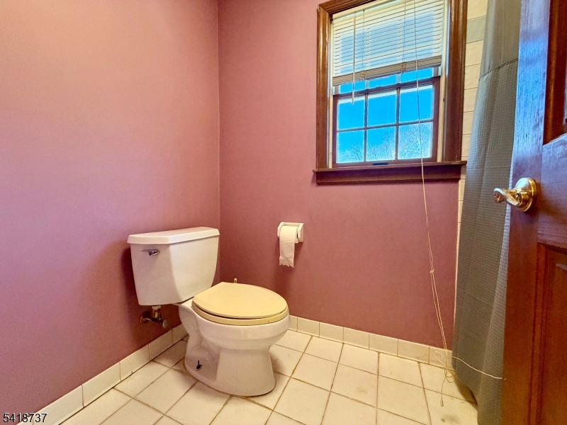 189 School House Road Oak Ridge, NJ 07438 - Photo 24 of 29 a white toilet sitting next to a window
