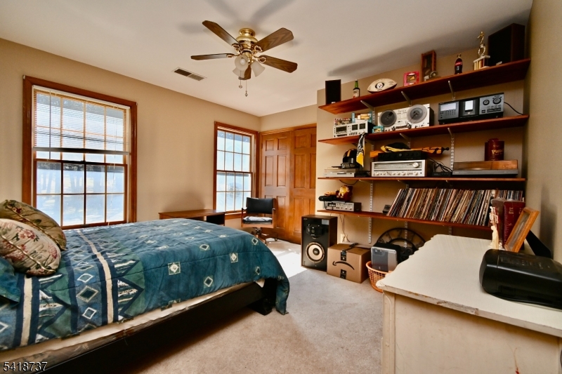 189 School House Road Oak Ridge, NJ 07438 - Photo 25 of 29 a bed room with a bed and a book shelf