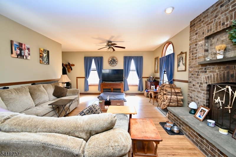 189 School House Road Oak Ridge, NJ 07438 - Photo 3 of 29 a living room with furniture a fireplace and a flat screen tv