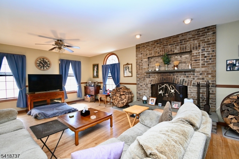 189 School House Road Oak Ridge, NJ 07438 - Photo 4 of 29 a living room with furniture a fireplace and a flat screen tv