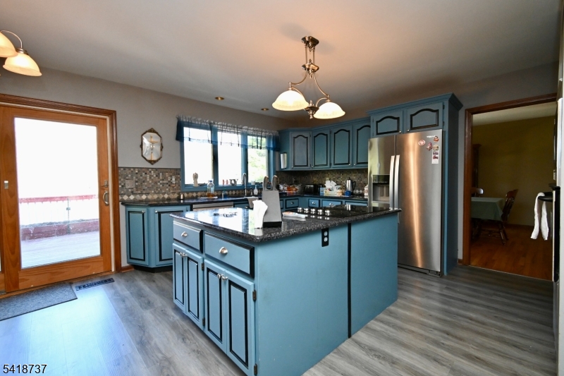 189 School House Road Oak Ridge, NJ 07438 - Photo 6 of 29 a kitchen with stainless steel appliances granite countertop a sink stove and refrigerator