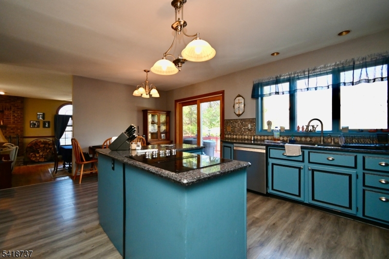 189 School House Road Oak Ridge, NJ 07438 - Photo 8 of 29 a kitchen with stainless steel appliances granite countertop a sink a stove and a wooden floors