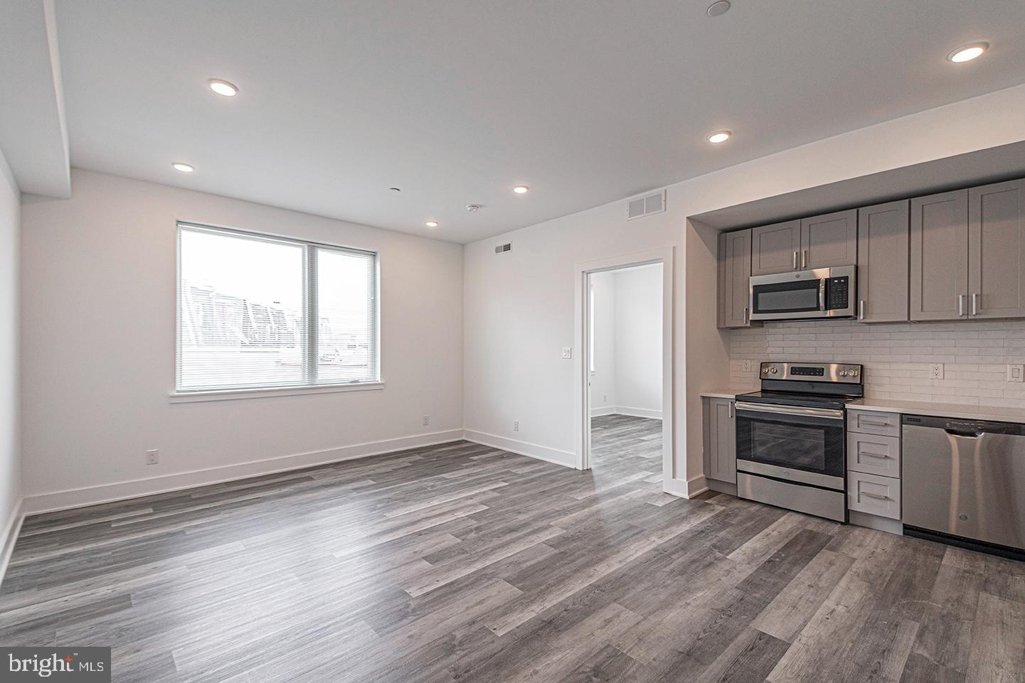 1245 Ridge Avenue, Unit 309 Philadelphia, PA 19123 - Photo 1 of 21 a kitchen with stainless steel appliances granite countertop a stove and a refrigerator