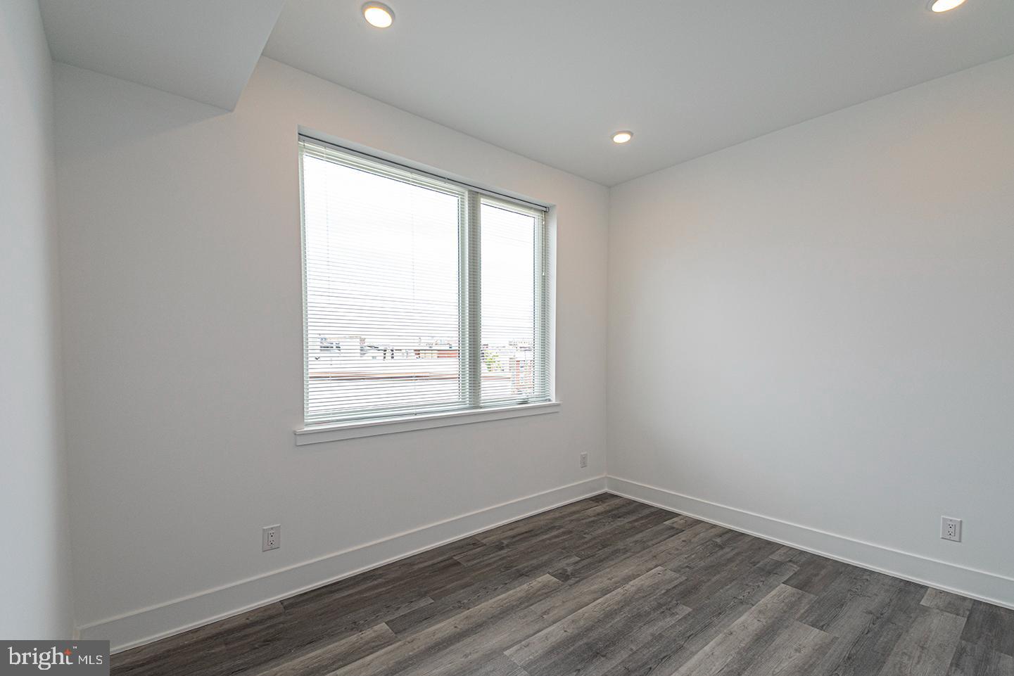 1245 Ridge Avenue, Unit 309 Philadelphia, PA 19123 - Photo 13 of 21 an empty room with wooden floor and windows