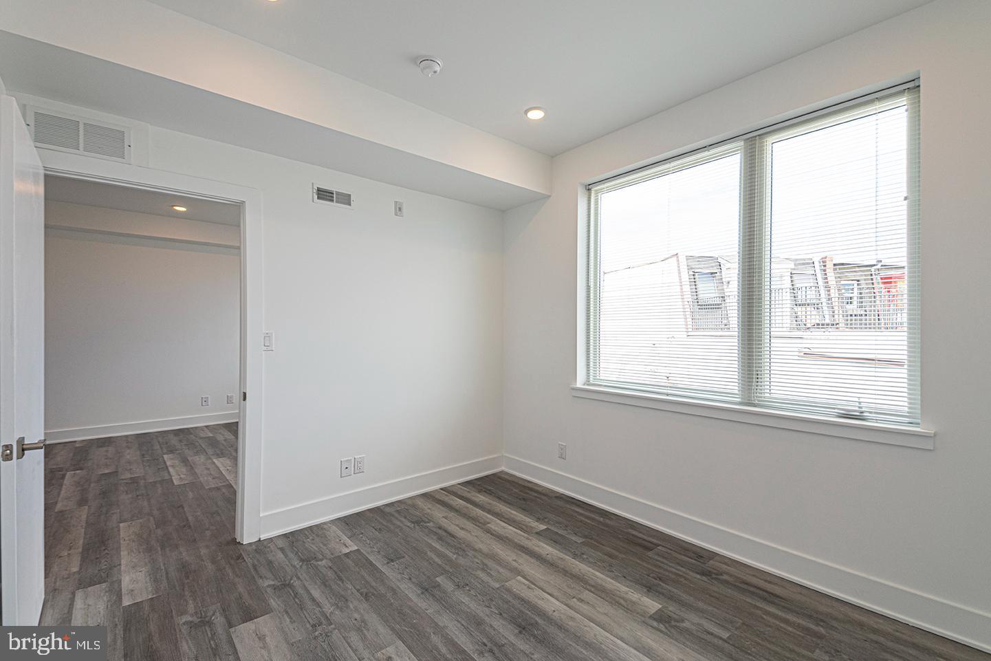 1245 Ridge Avenue, Unit 309 Philadelphia, PA 19123 - Photo 16 of 21 an empty room with wooden floor and windows