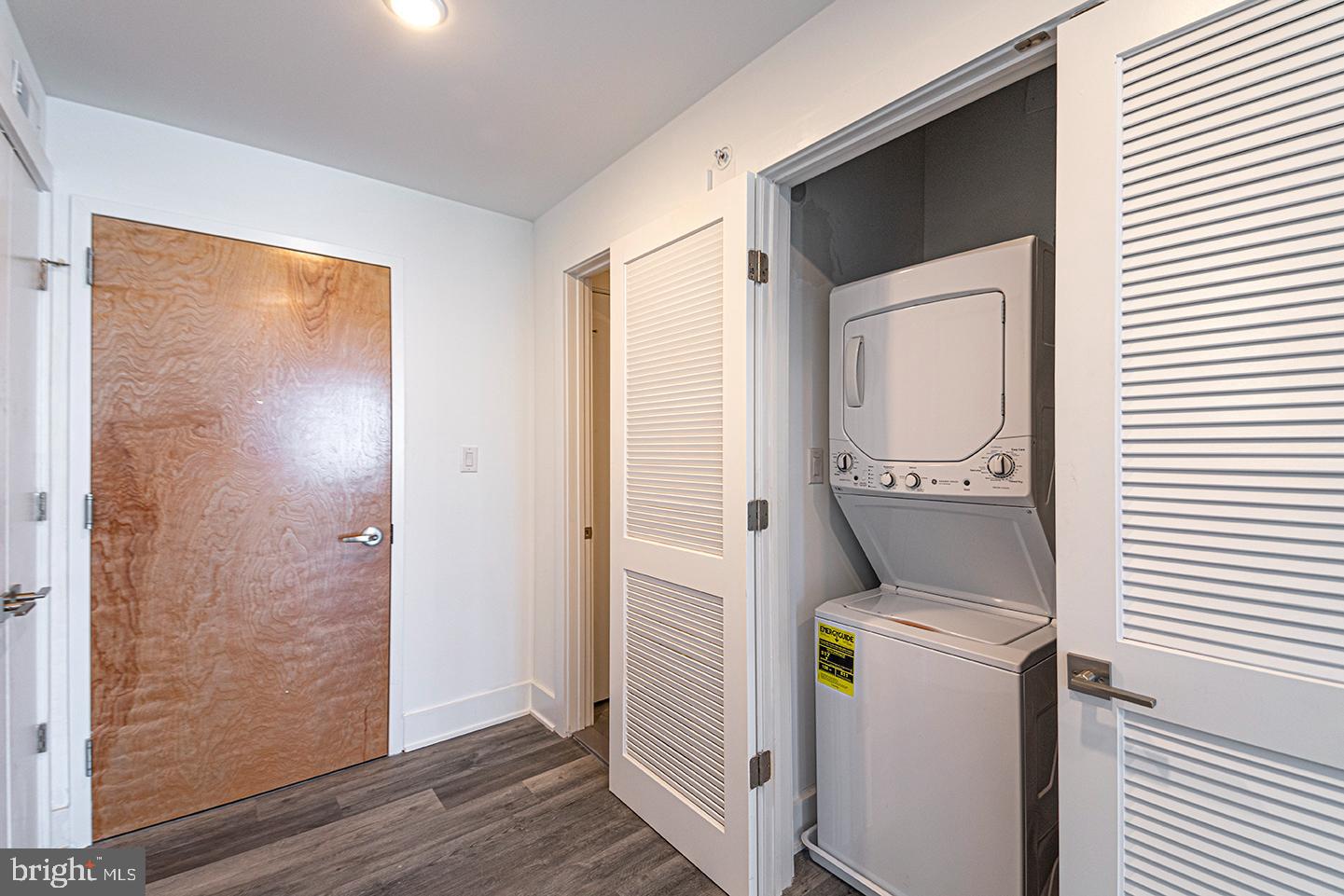 1245 Ridge Avenue, Unit 309 Philadelphia, PA 19123 - Photo 6 of 21 a view of washer and dryer with wooden floor